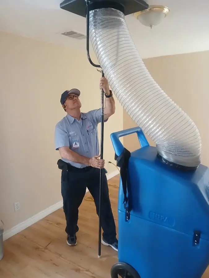 Furnace Tune-Up technician using HEPA equipment in Hutto
